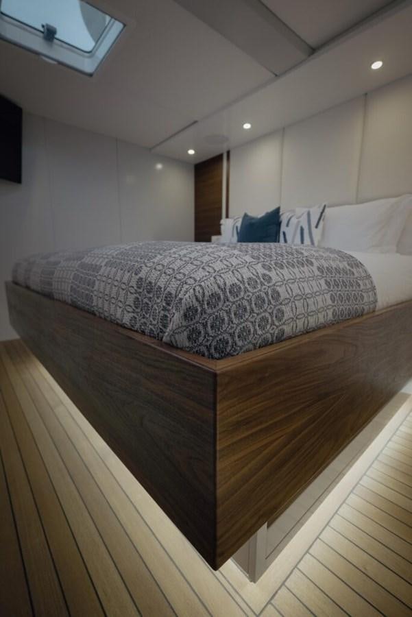 a bed with a white comforter aboard SALTY Yacht for Sale