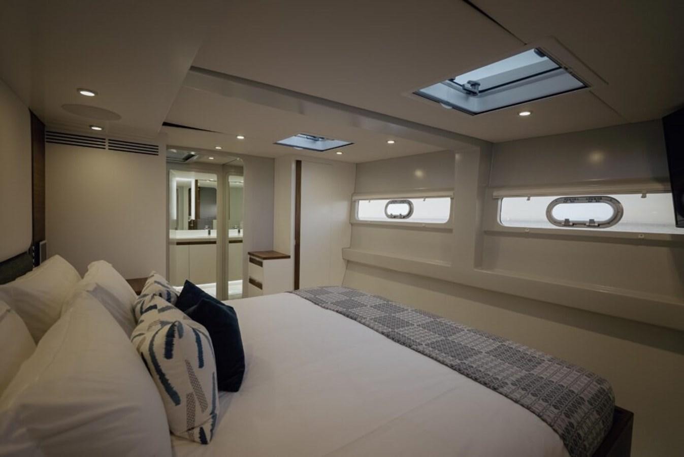 a large bedroom with a bed aboard SALTY Yacht for Sale