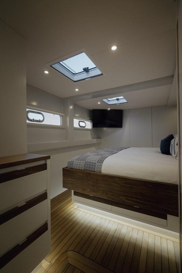 a room with a bed and a window aboard SALTY Yacht for Sale