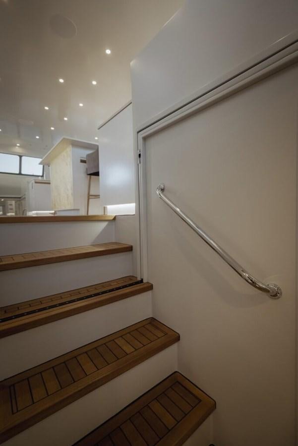 a wooden staircase with wooden railings aboard SALTY Yacht for Sale