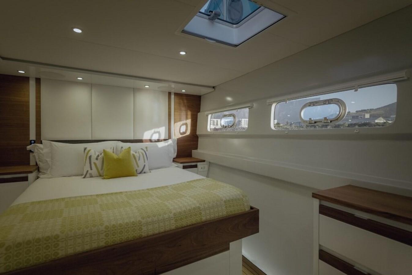 a room with a bed and a television on the wall aboard SALTY Yacht for Sale