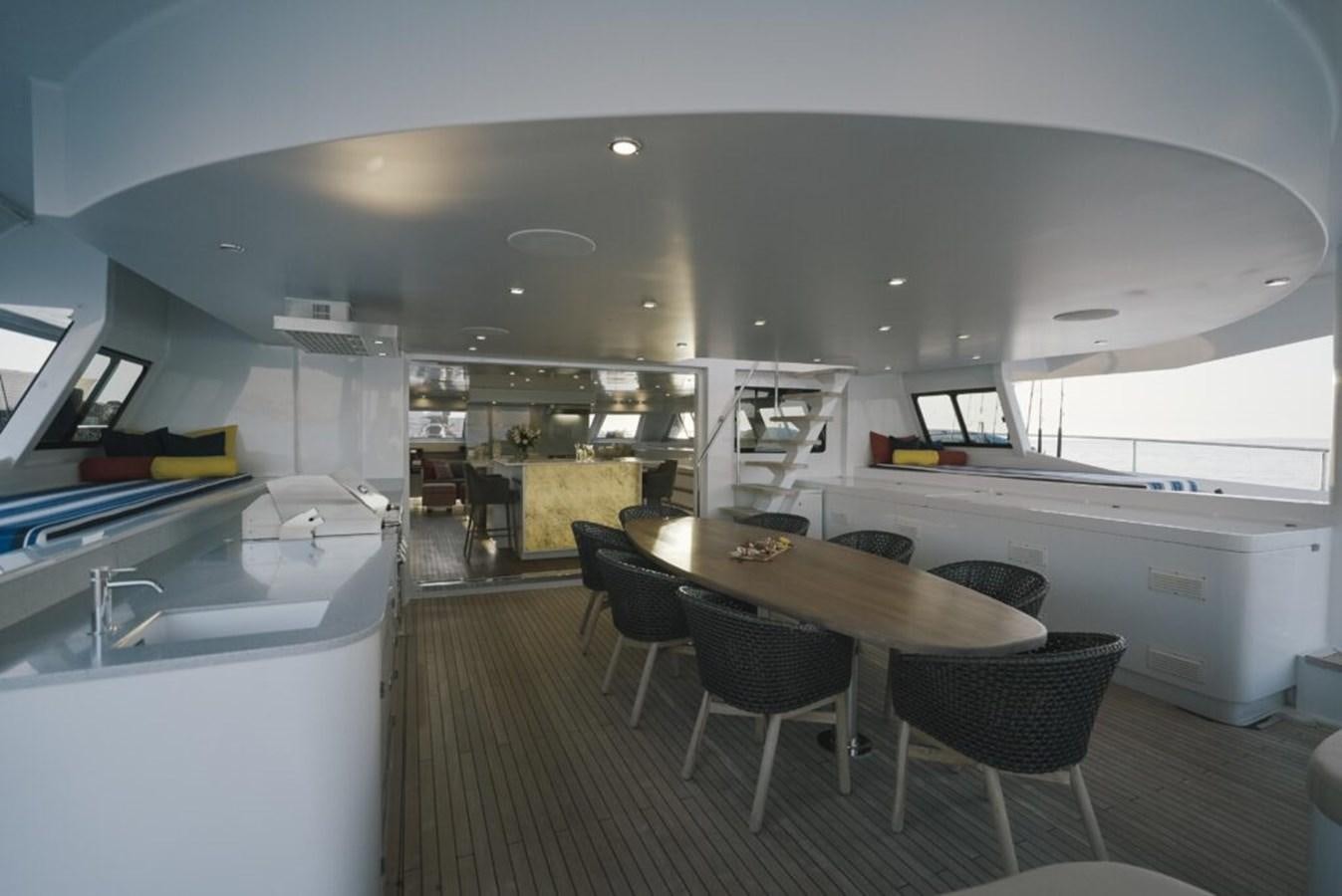 a large kitchen with a table and chairs aboard SALTY Yacht for Sale