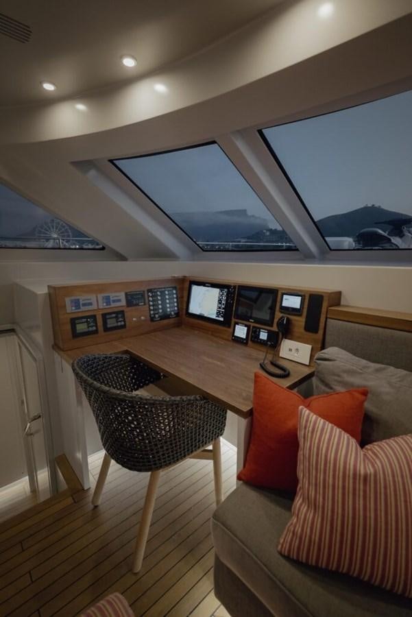 a living room with a table and chairs aboard SALTY Yacht for Sale