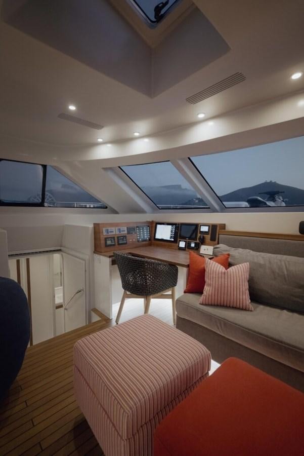 a room with a couch and a table and a tv aboard SALTY Yacht for Sale