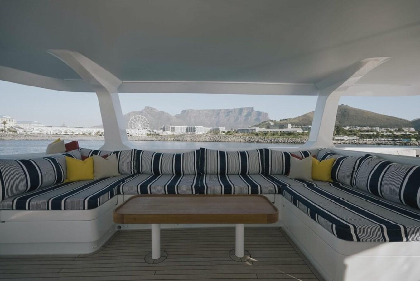 a room with a bench and a view of a city aboard SALTY Yacht for Sale