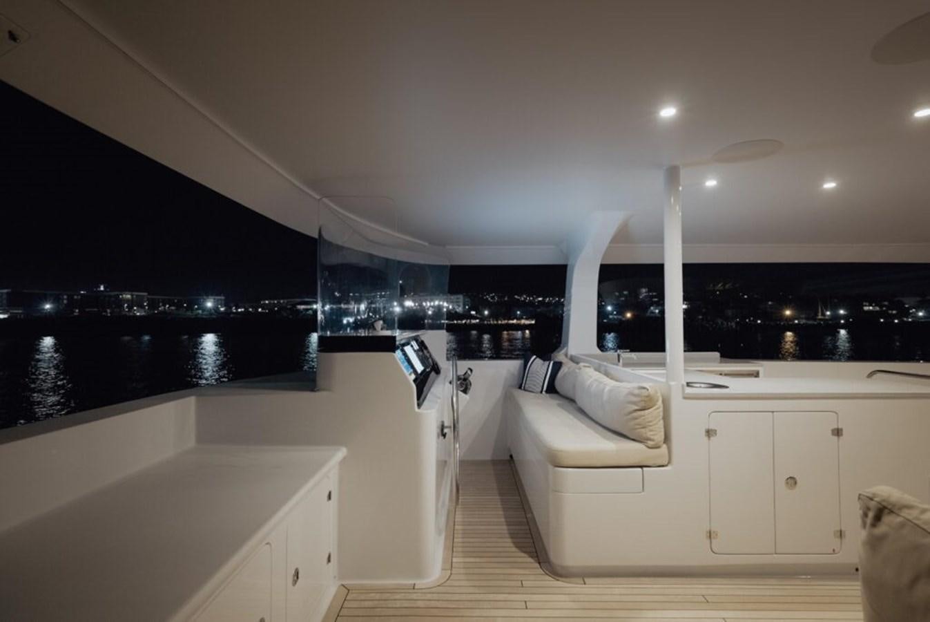 a modern kitchen with white cabinets aboard SALTY Yacht for Sale