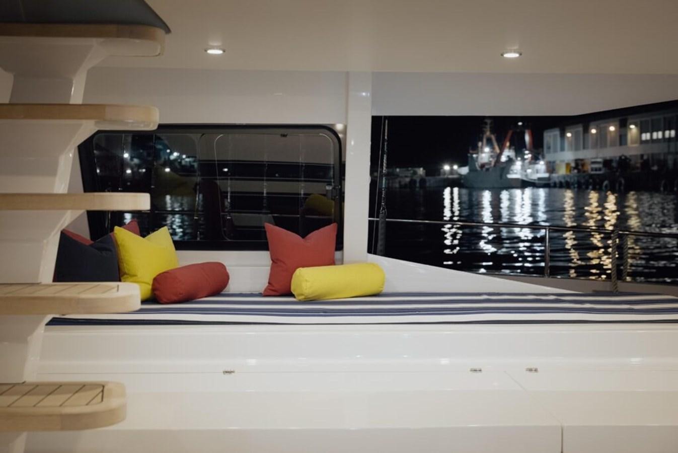a room with a large mirror and colorful pillows aboard SALTY Yacht for Sale
