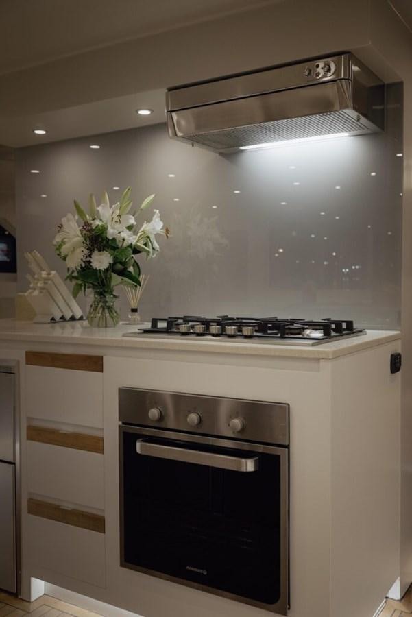 a kitchen with a stove and oven aboard SALTY Yacht for Sale