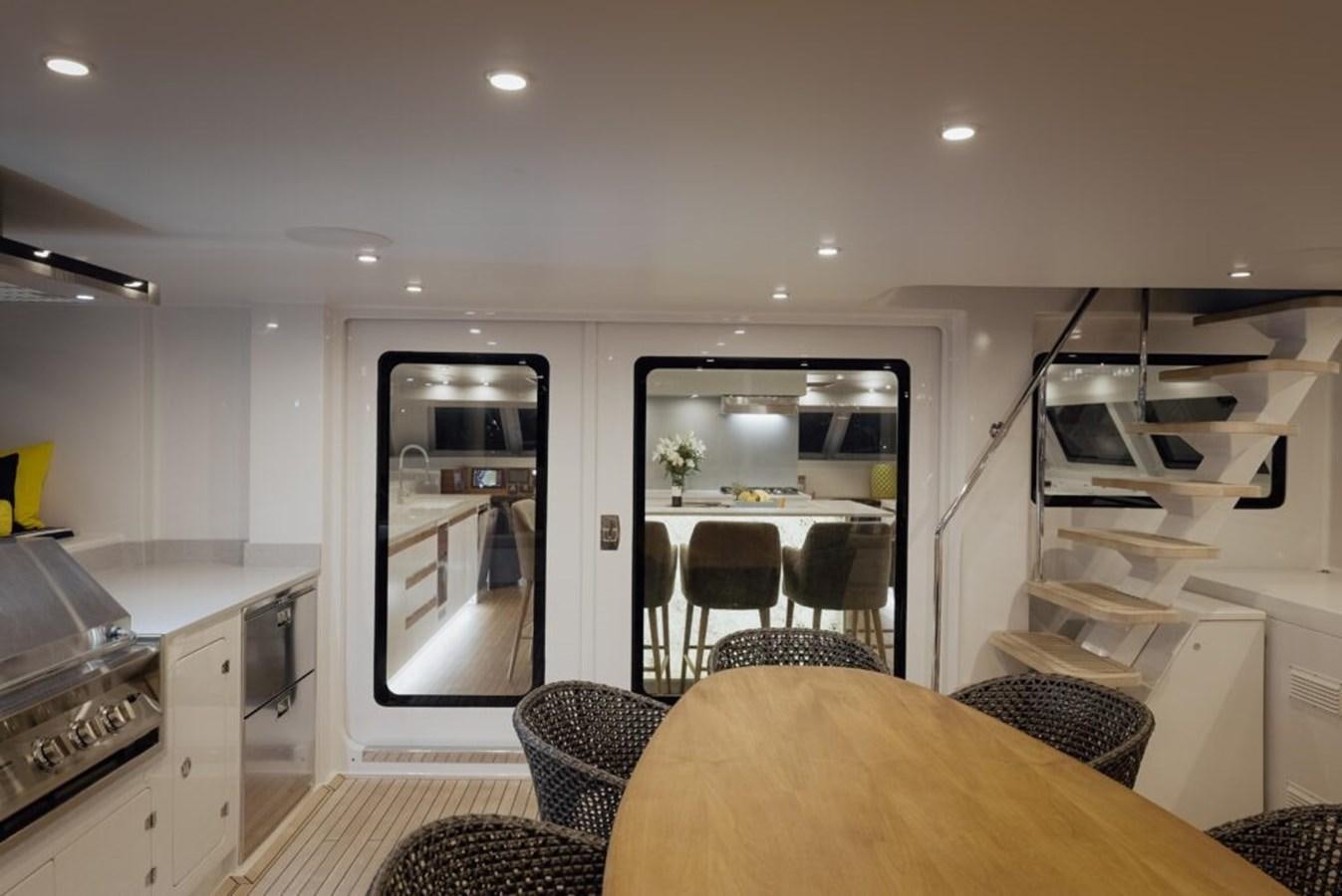 a kitchen with a dining table aboard SALTY Yacht for Sale