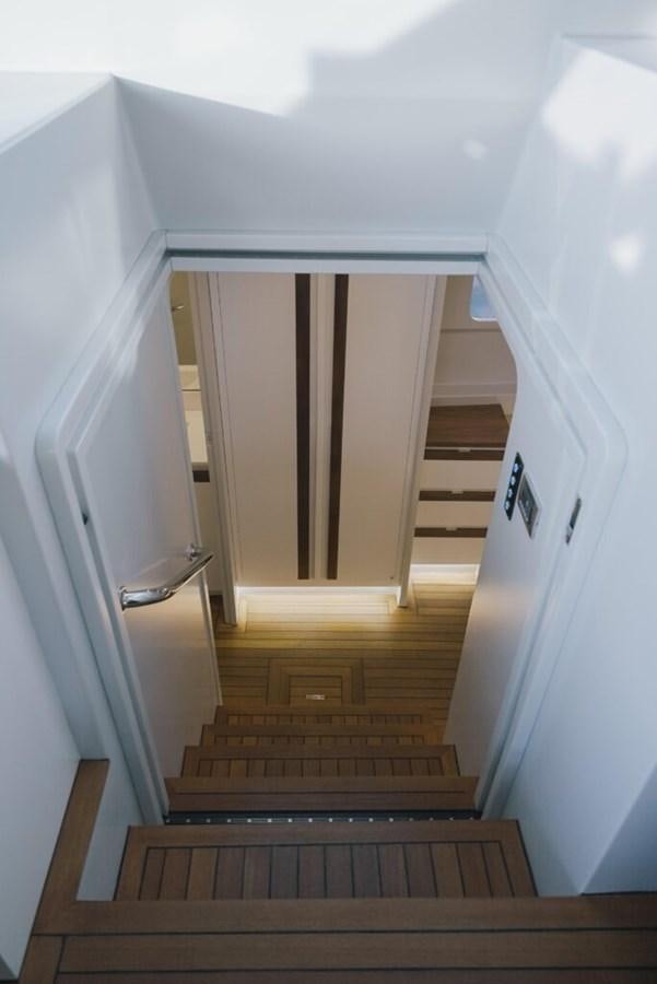 a hallway with a wood floor and a door aboard SALTY Yacht for Sale