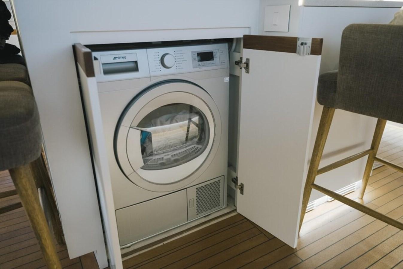 a white washing machine aboard SALTY Yacht for Sale