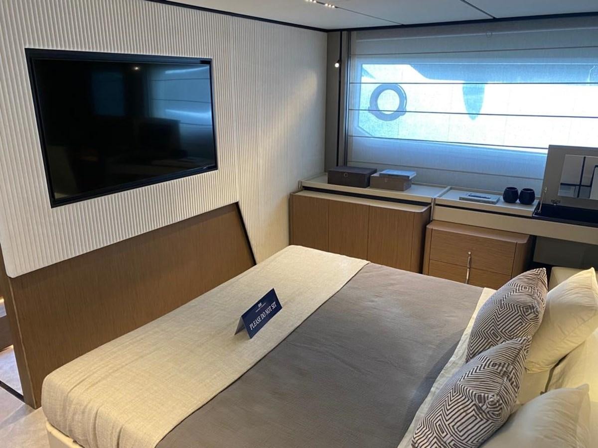 a bed with a television on the wall aboard MY ANGEL Yacht for Sale