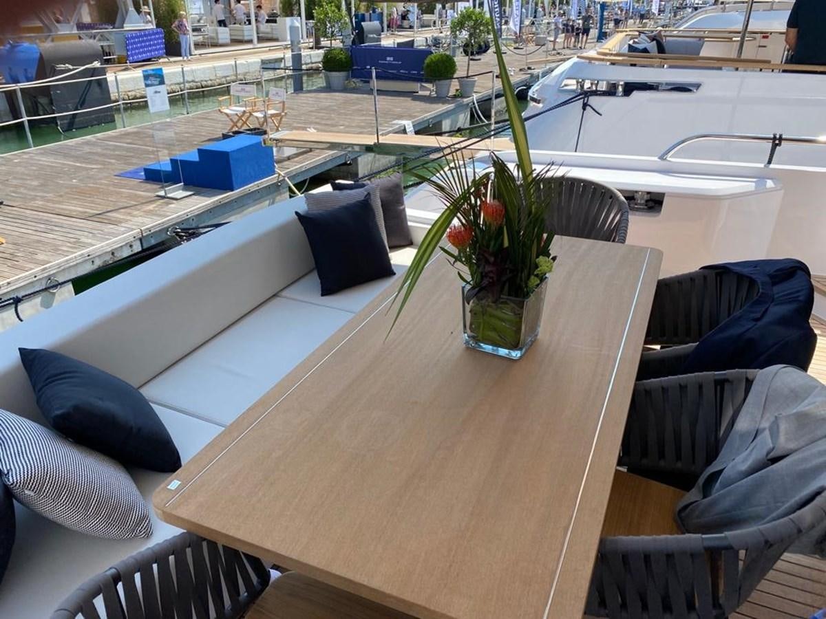 a table with chairs and a plant on it aboard MY ANGEL Yacht for Sale