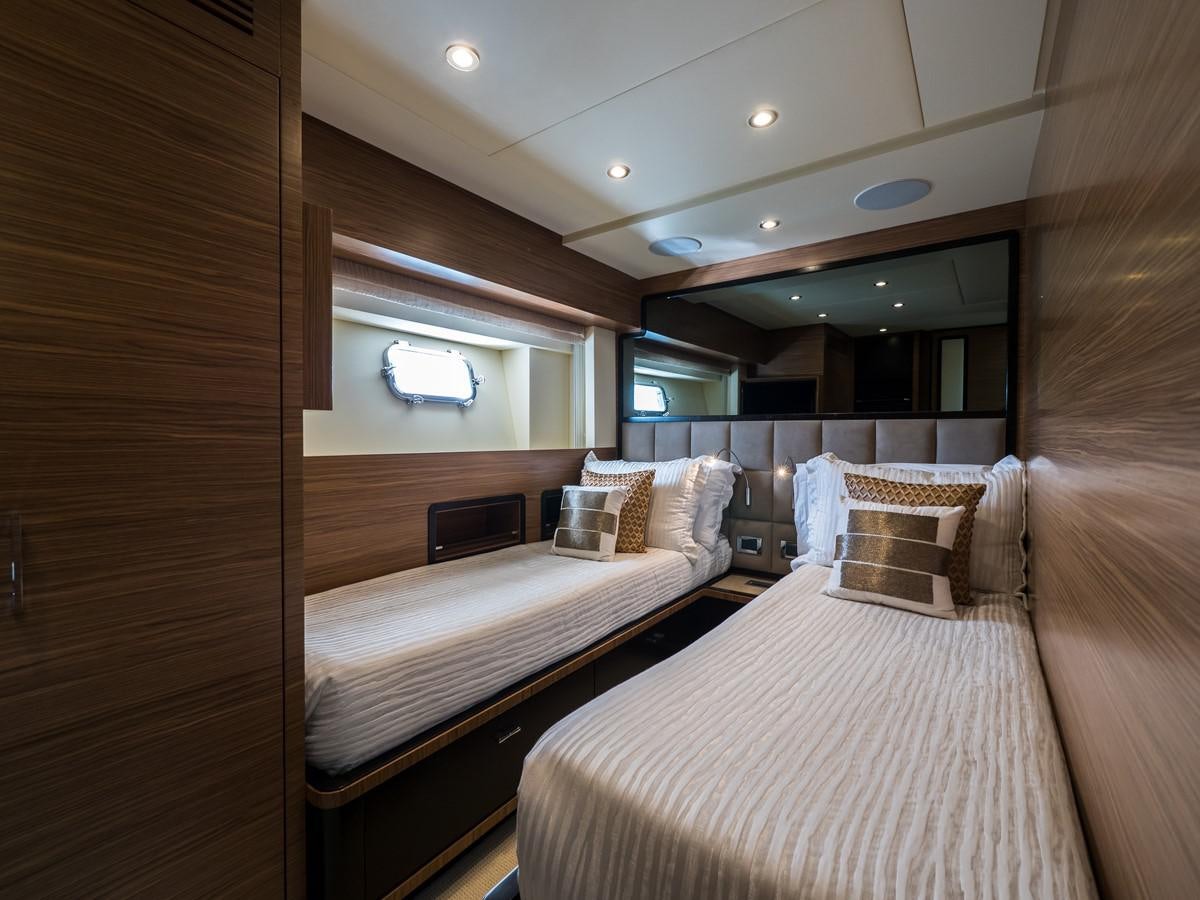 a room with a bed and a television aboard 2016 AZIMUT 76 MAGELLANO THE EQUITES Yacht for Sale