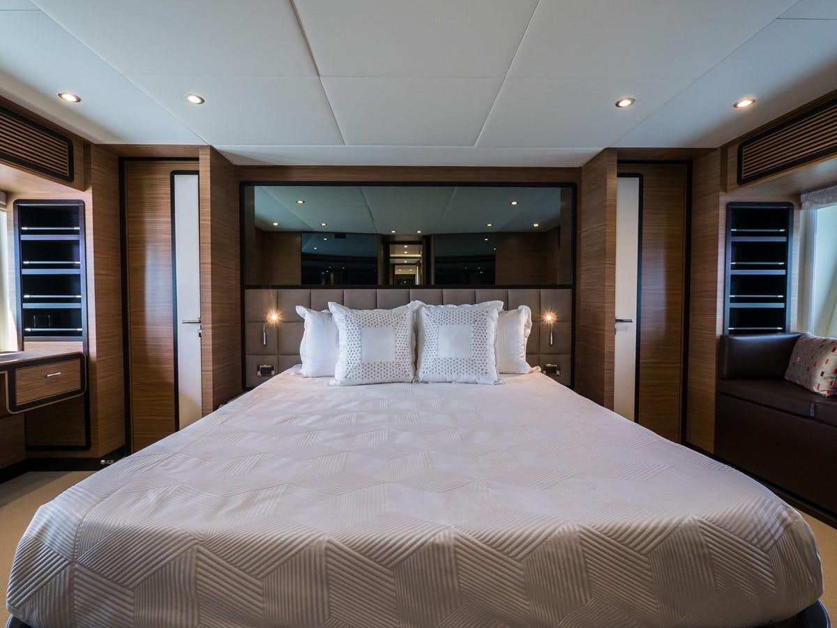 a large bed in a hotel room aboard 2016 AZIMUT 76 MAGELLANO THE EQUITES Yacht for Sale