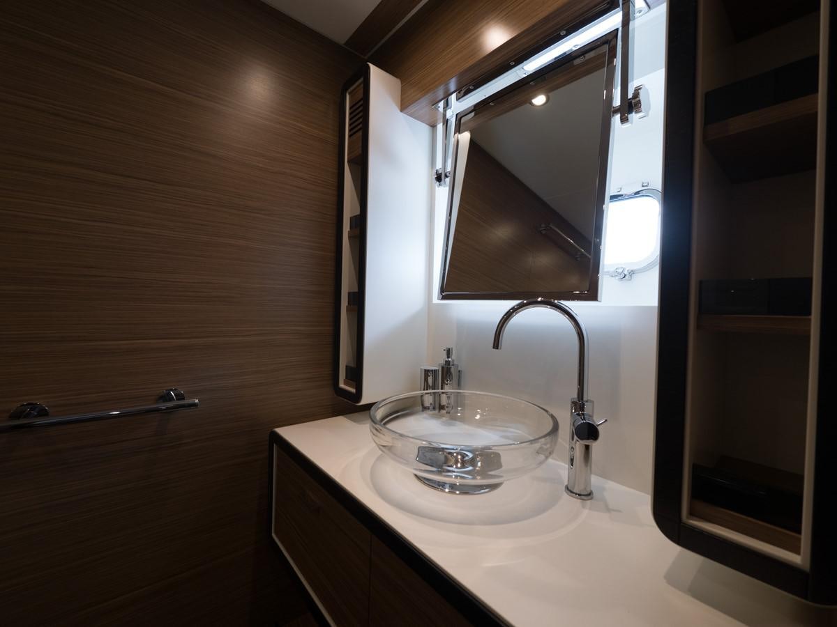 a bathroom with a sink and a mirror aboard 2016 AZIMUT 76 MAGELLANO THE EQUITES Yacht for Sale