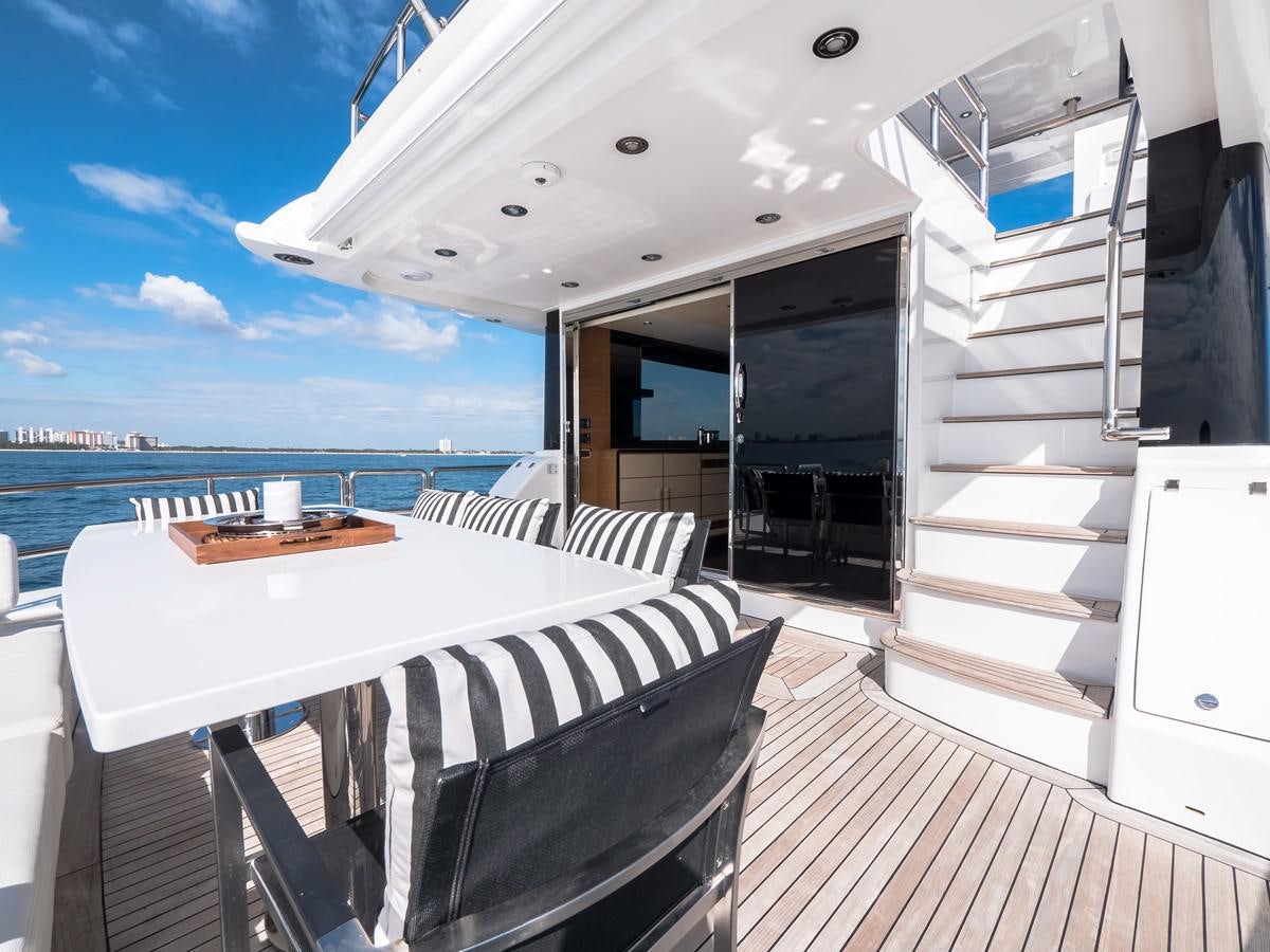 a room with a table and chairs aboard 2016 AZIMUT 76 MAGELLANO THE EQUITES Yacht for Sale