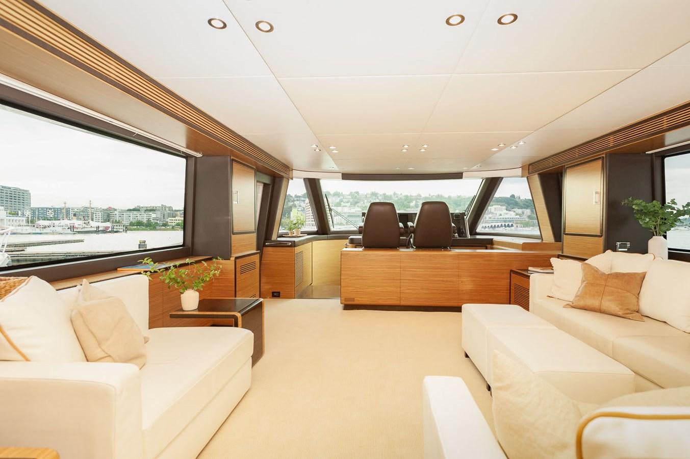 a large living room with a large window aboard 2016 AZIMUT 76 MAGELLANO THE EQUITES Yacht for Sale