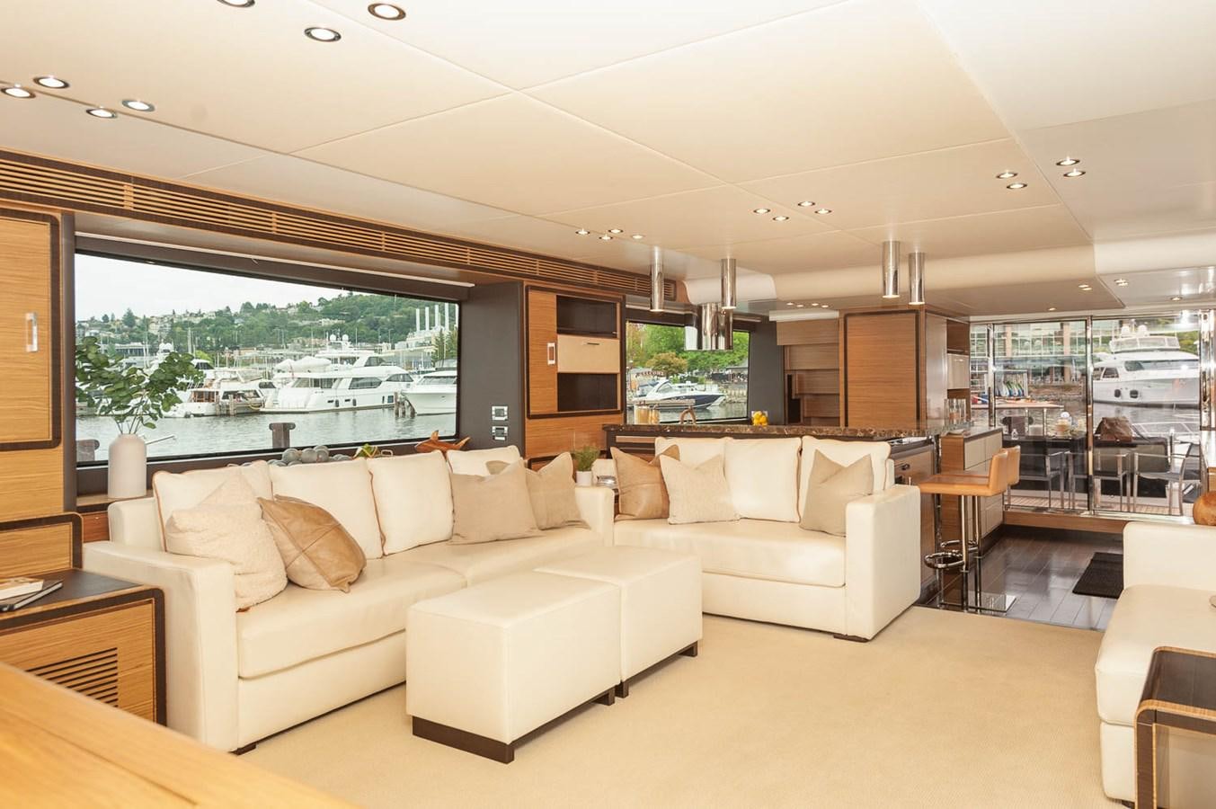a living room with a large window aboard 2016 AZIMUT 76 MAGELLANO THE EQUITES Yacht for Sale
