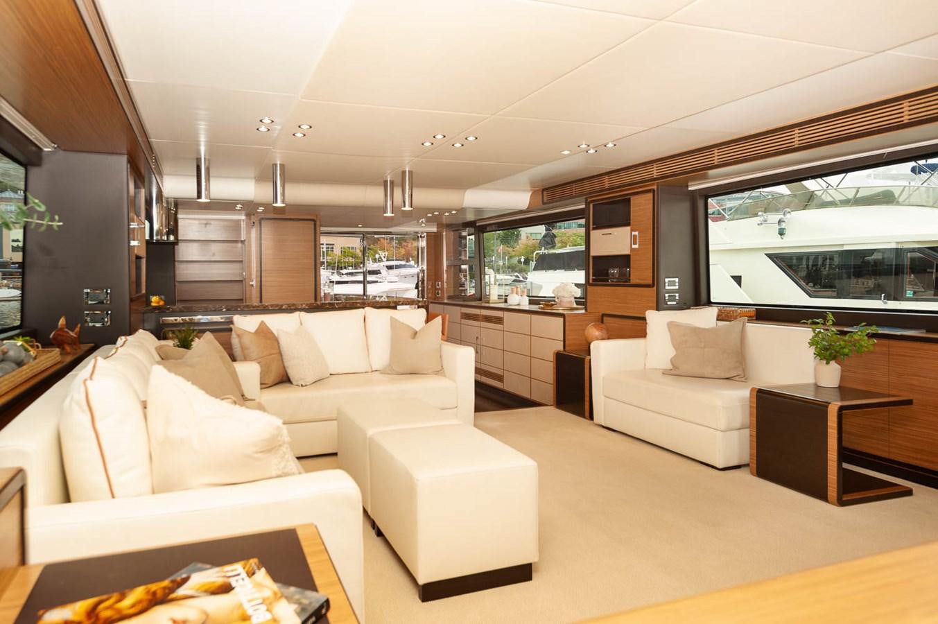 a living room with white furniture aboard 2016 AZIMUT 76 MAGELLANO THE EQUITES Yacht for Sale