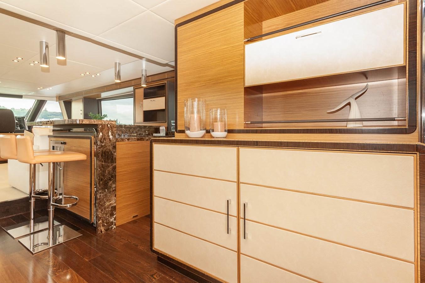 a kitchen with wooden cabinets aboard 2016 AZIMUT 76 MAGELLANO THE EQUITES Yacht for Sale