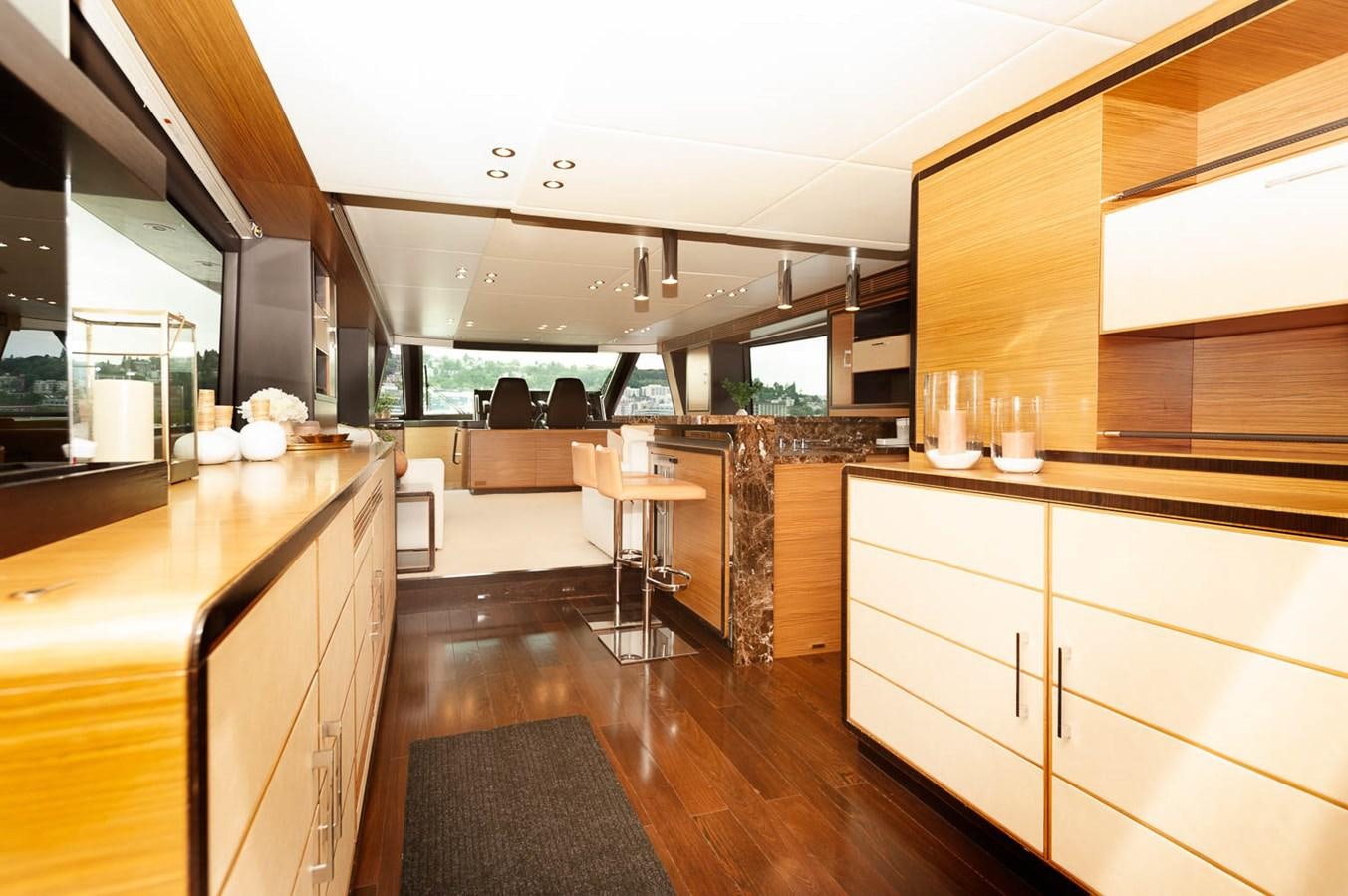 a kitchen with wooden cabinets aboard 2016 AZIMUT 76 MAGELLANO THE EQUITES Yacht for Sale