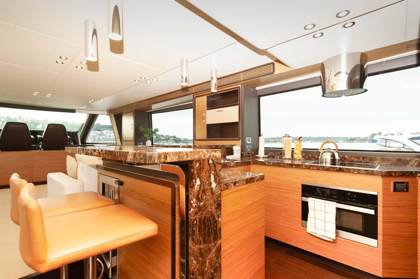 a kitchen with a large window aboard 2016 AZIMUT 76 MAGELLANO THE EQUITES Yacht for Sale