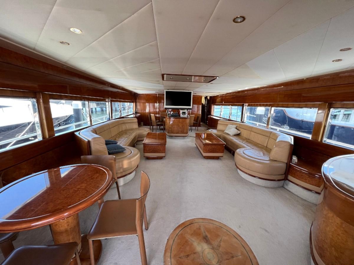 a living room with a wood table aboard BENSHIP 101 Yacht for Sale