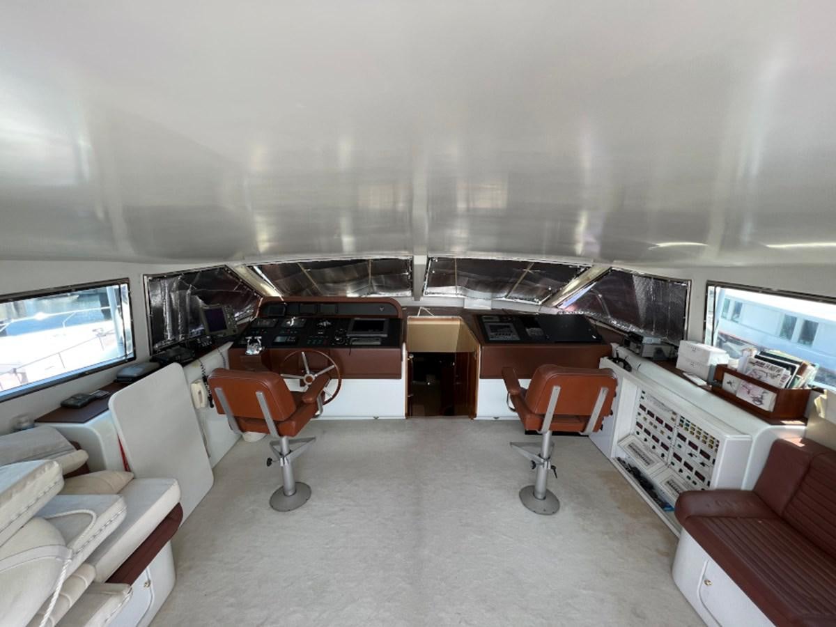 an empty office with a desk and chairs aboard BENSHIP 101 Yacht for Sale