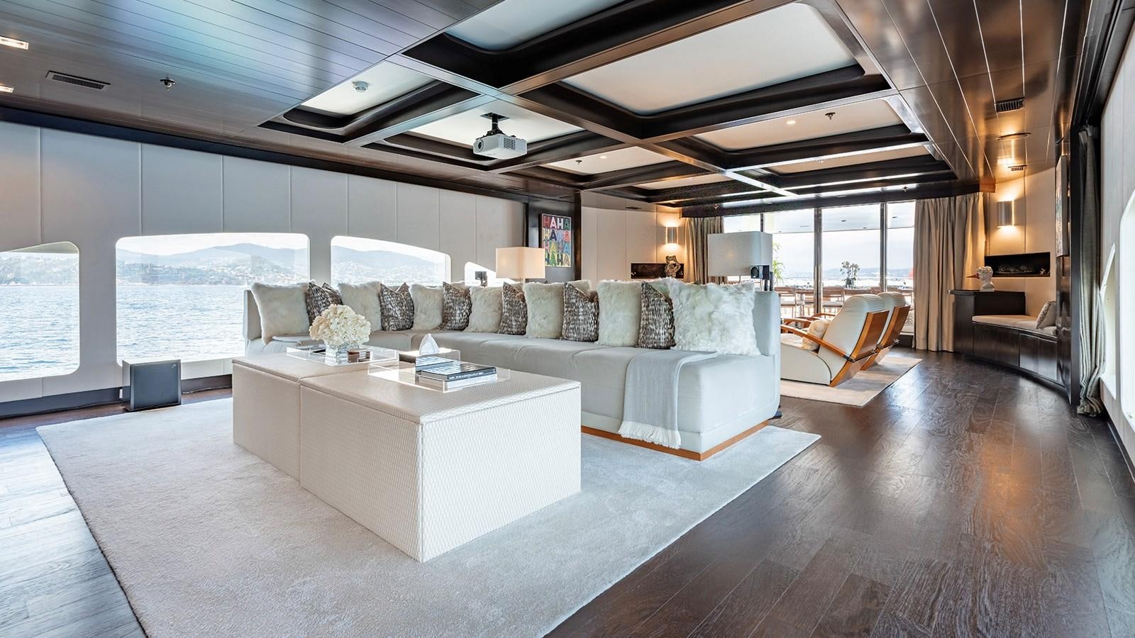 a large living room with a large window aboard LOTUS Yacht for Sale