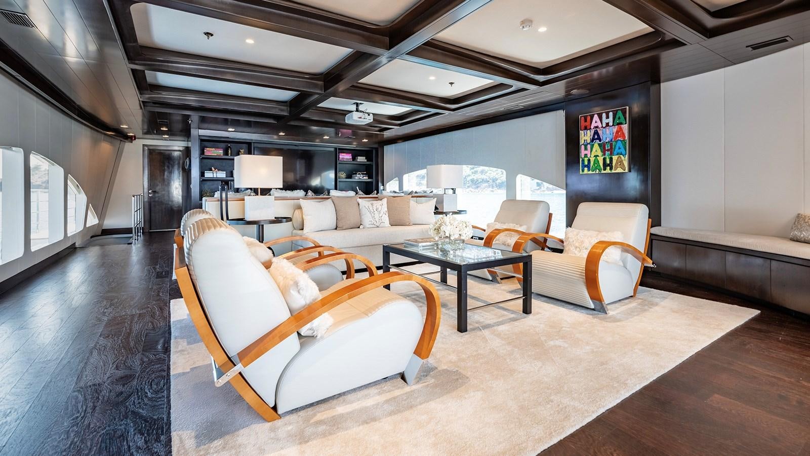 a living room with a couch and a table aboard LOTUS Yacht for Sale