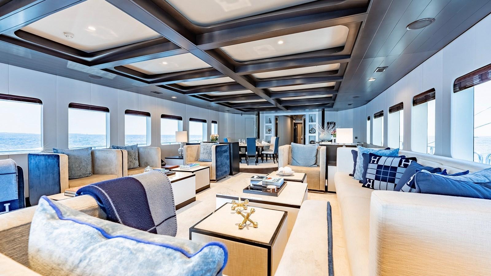 a room with a couch and a table aboard LOTUS Yacht for Sale