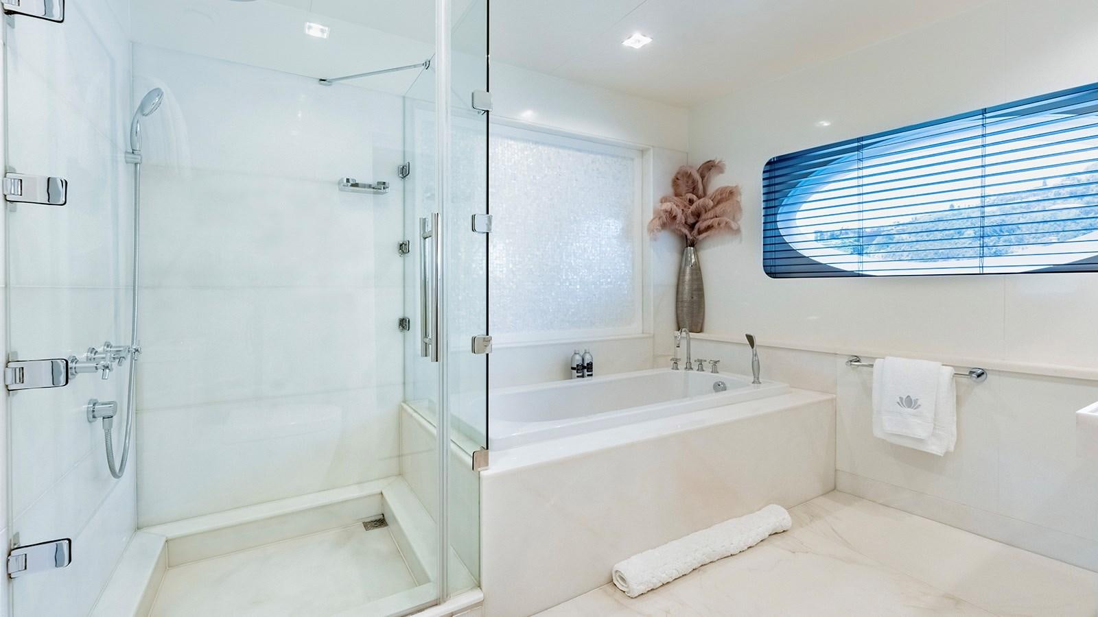 a bathroom with a tub and shower aboard LOTUS Yacht for Sale