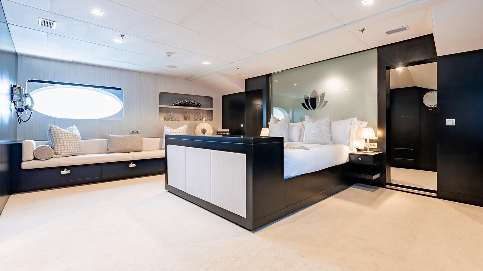 a room with a large bed and a tv aboard LOTUS Yacht for Sale