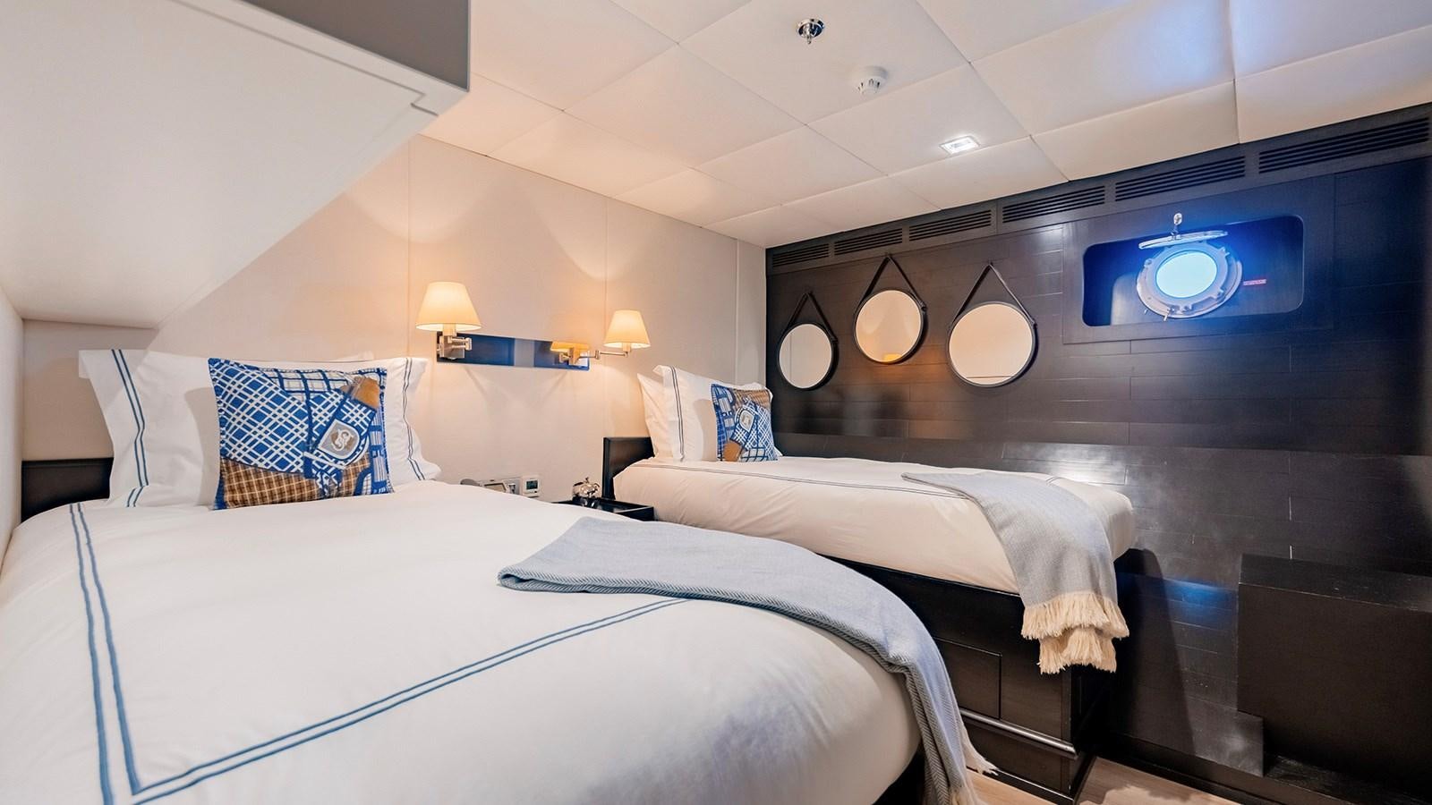 a room with two beds aboard LOTUS Yacht for Sale