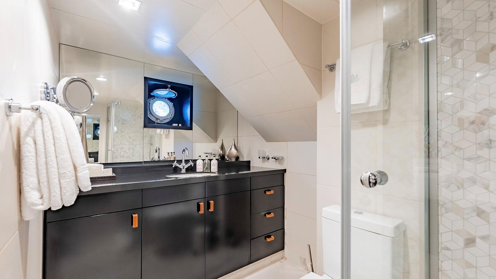 a bathroom with a sink and a mirror aboard LOTUS Yacht for Sale