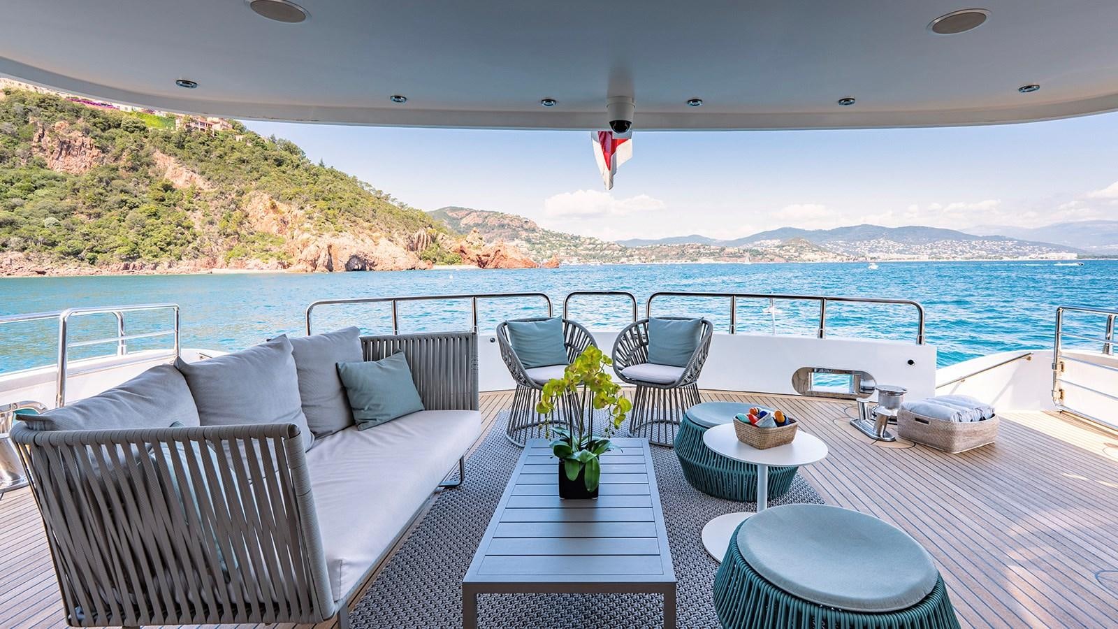 a balcony with a view of the ocean and mountains aboard LOTUS Yacht for Sale