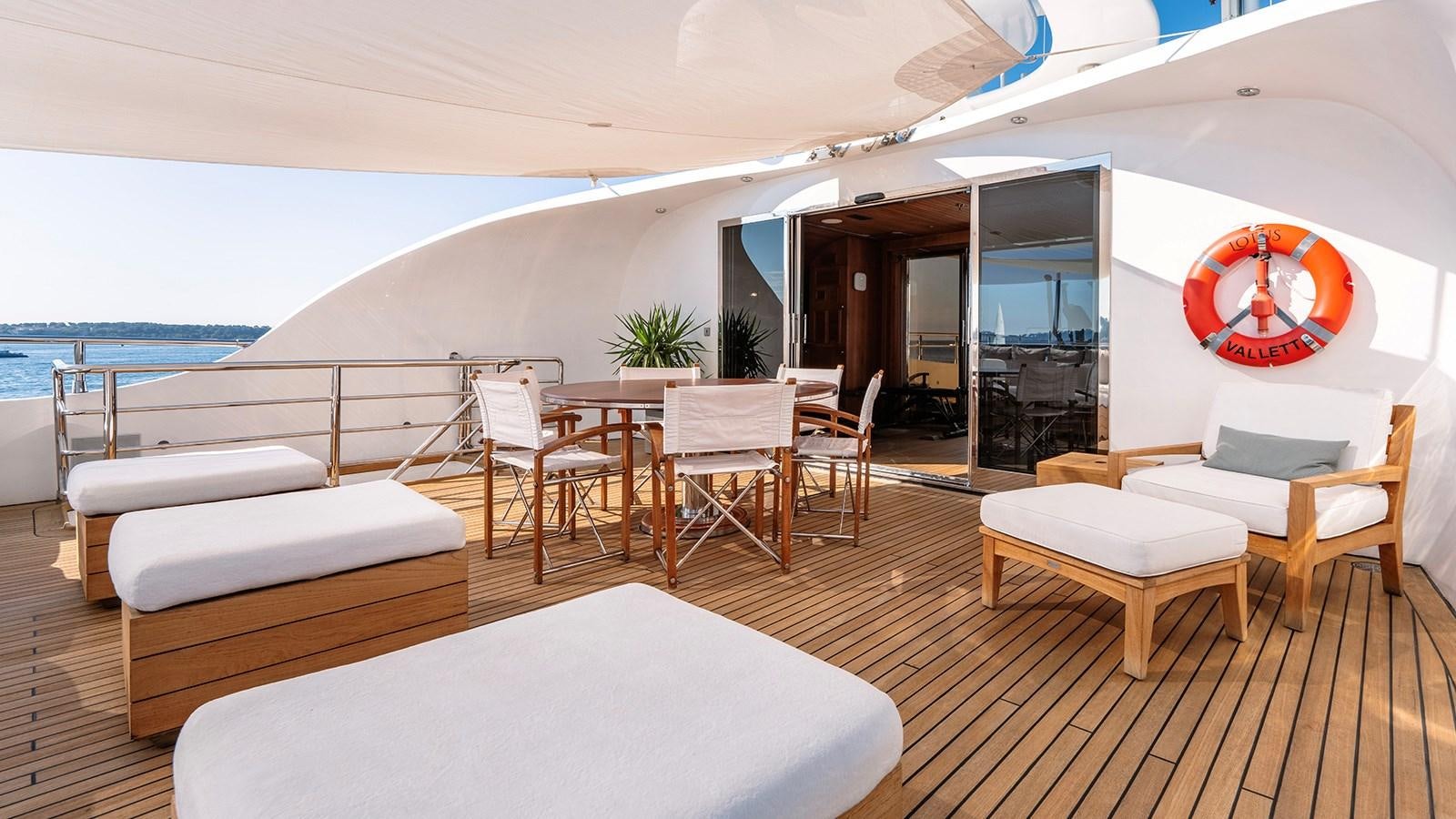 a room with a table and chairs aboard LOTUS Yacht for Sale