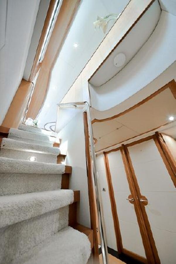 a staircase with a white wall aboard 2007 LAZZARA 84 MOTOR Yacht for Sale