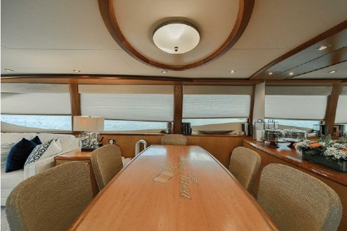 a room with a table and chairs aboard 2007 LAZZARA 84 MOTOR Yacht for Sale