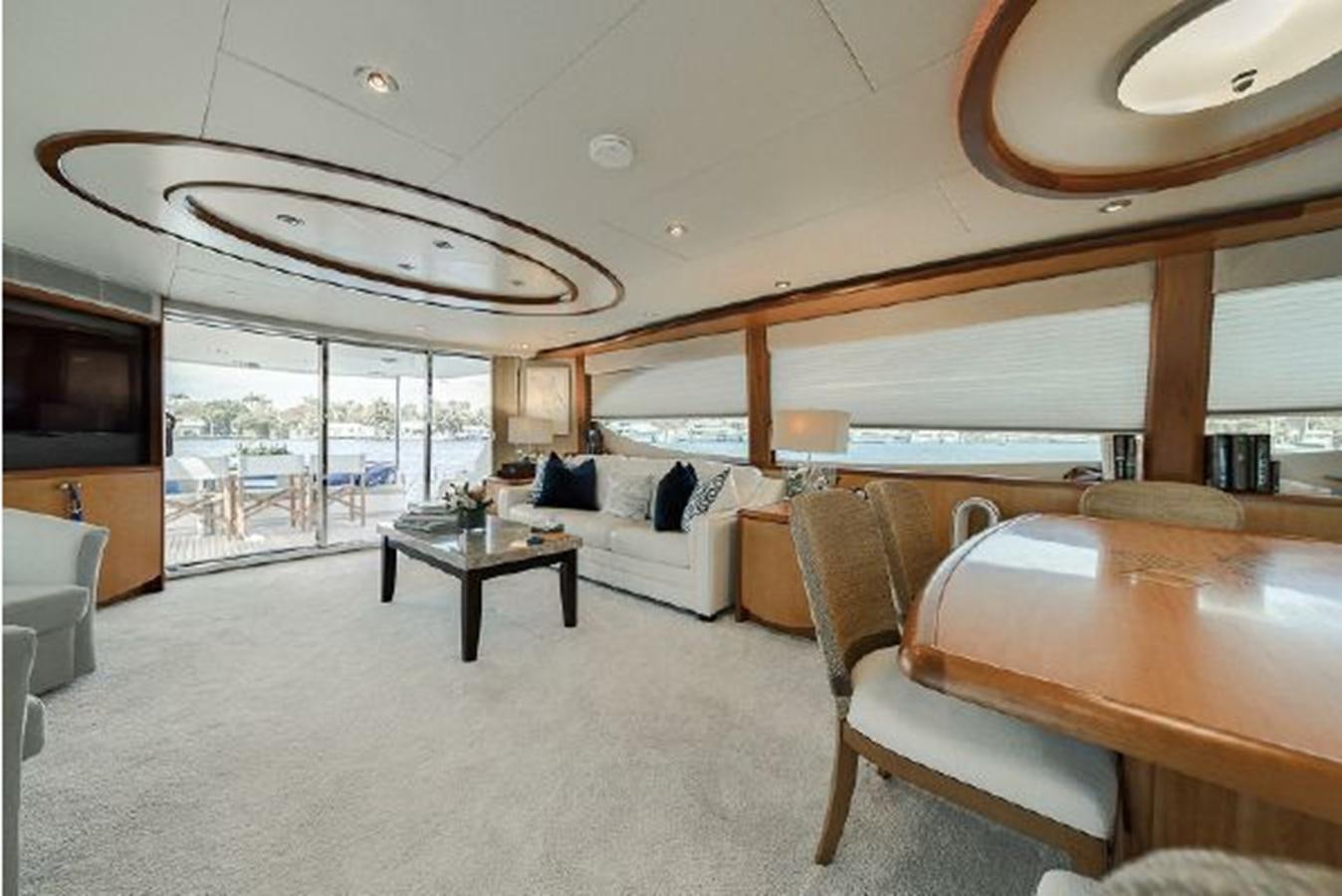 a room with a table and chairs aboard 2007 LAZZARA 84 MOTOR Yacht for Sale