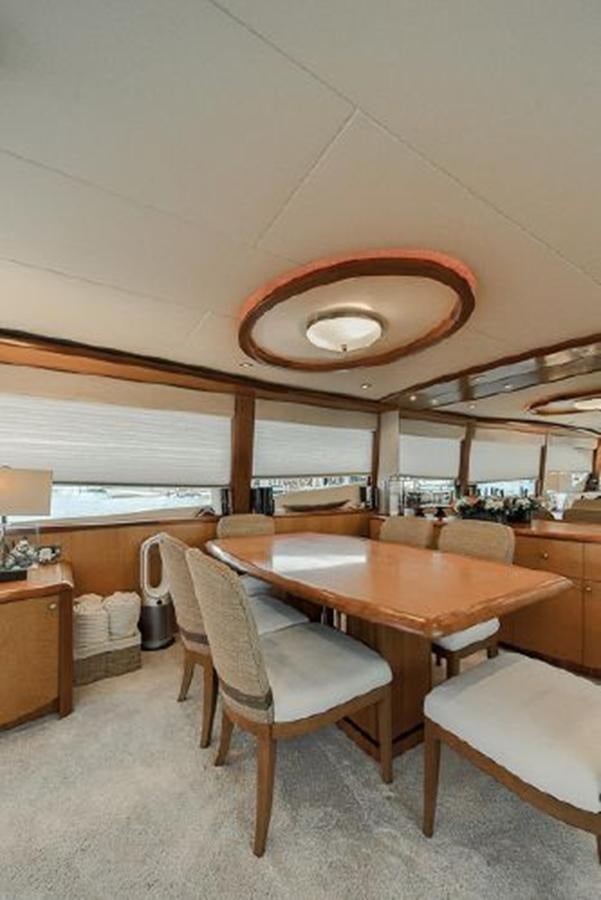 a room with a table and chairs aboard 2007 LAZZARA 84 MOTOR Yacht for Sale