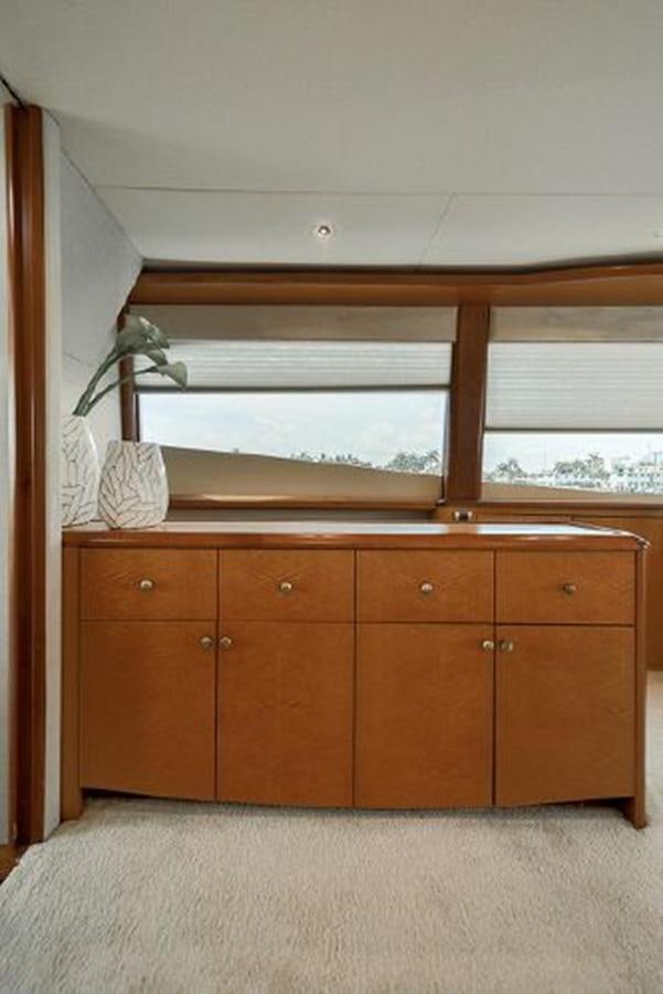 a room with wooden cabinets aboard 2007 LAZZARA 84 MOTOR Yacht for Sale