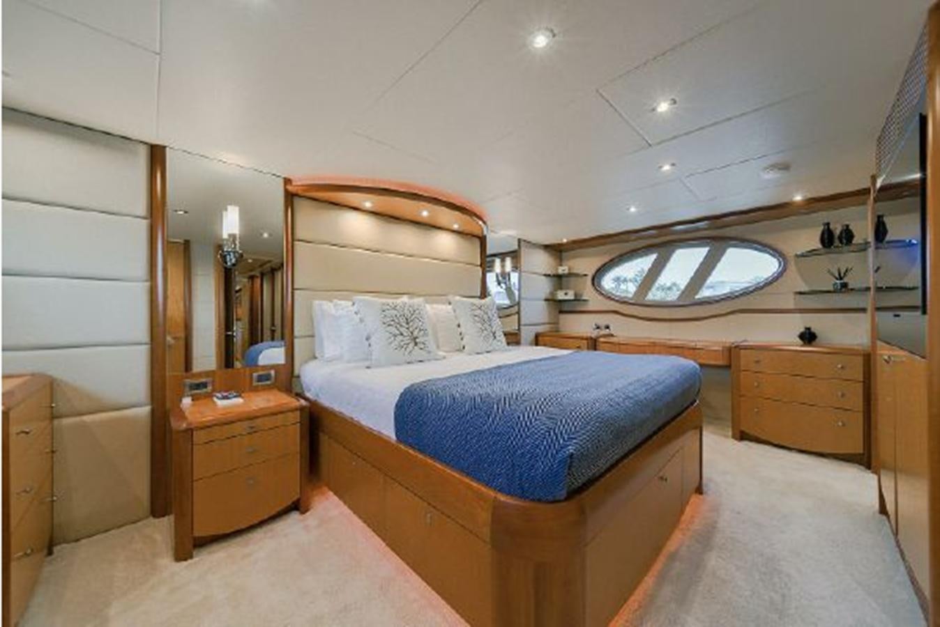 a bedroom with a bed and a mirror aboard 2007 LAZZARA 84 MOTOR Yacht for Sale