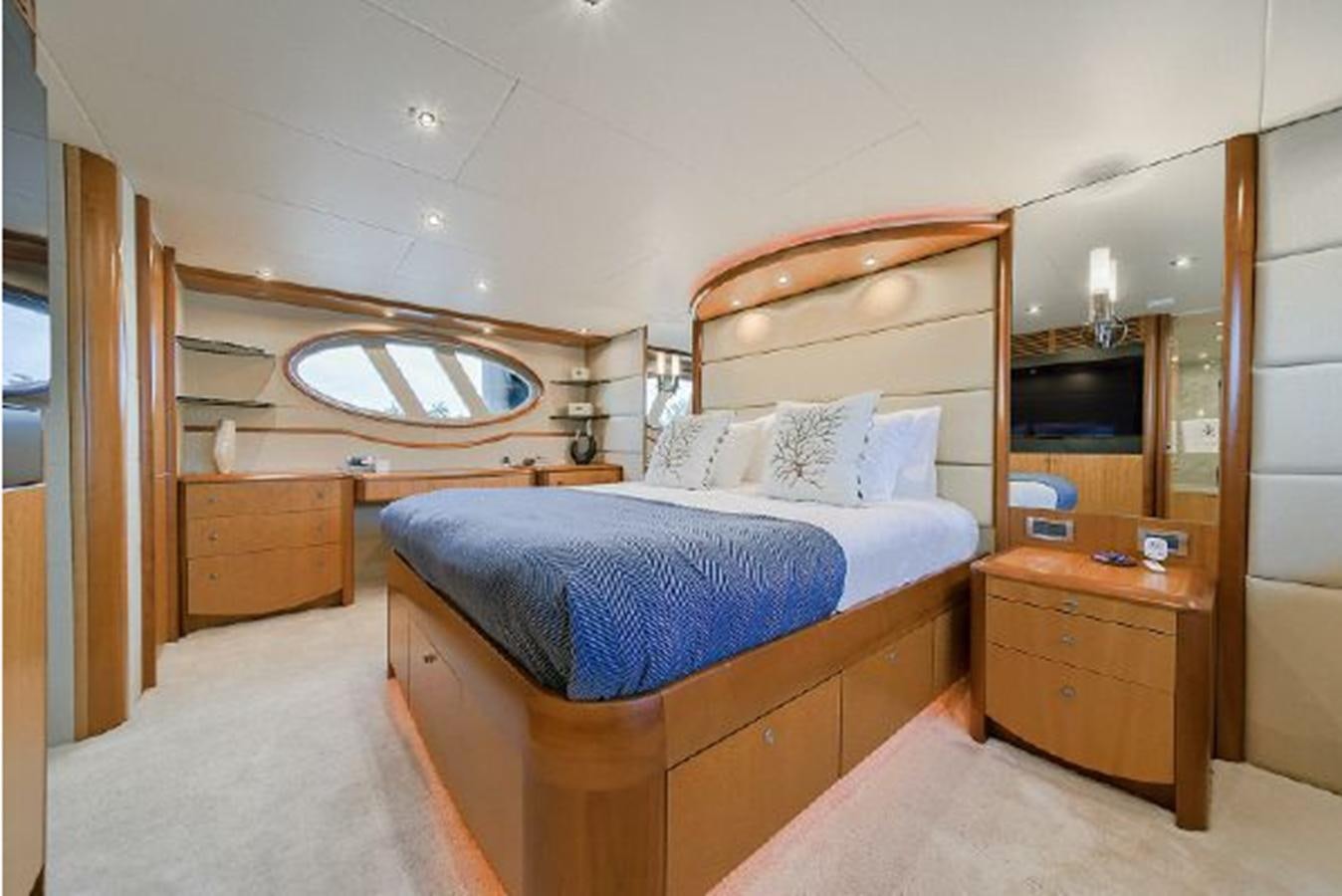 a bedroom with a bed and a mirror aboard 2007 LAZZARA 84 MOTOR Yacht for Sale