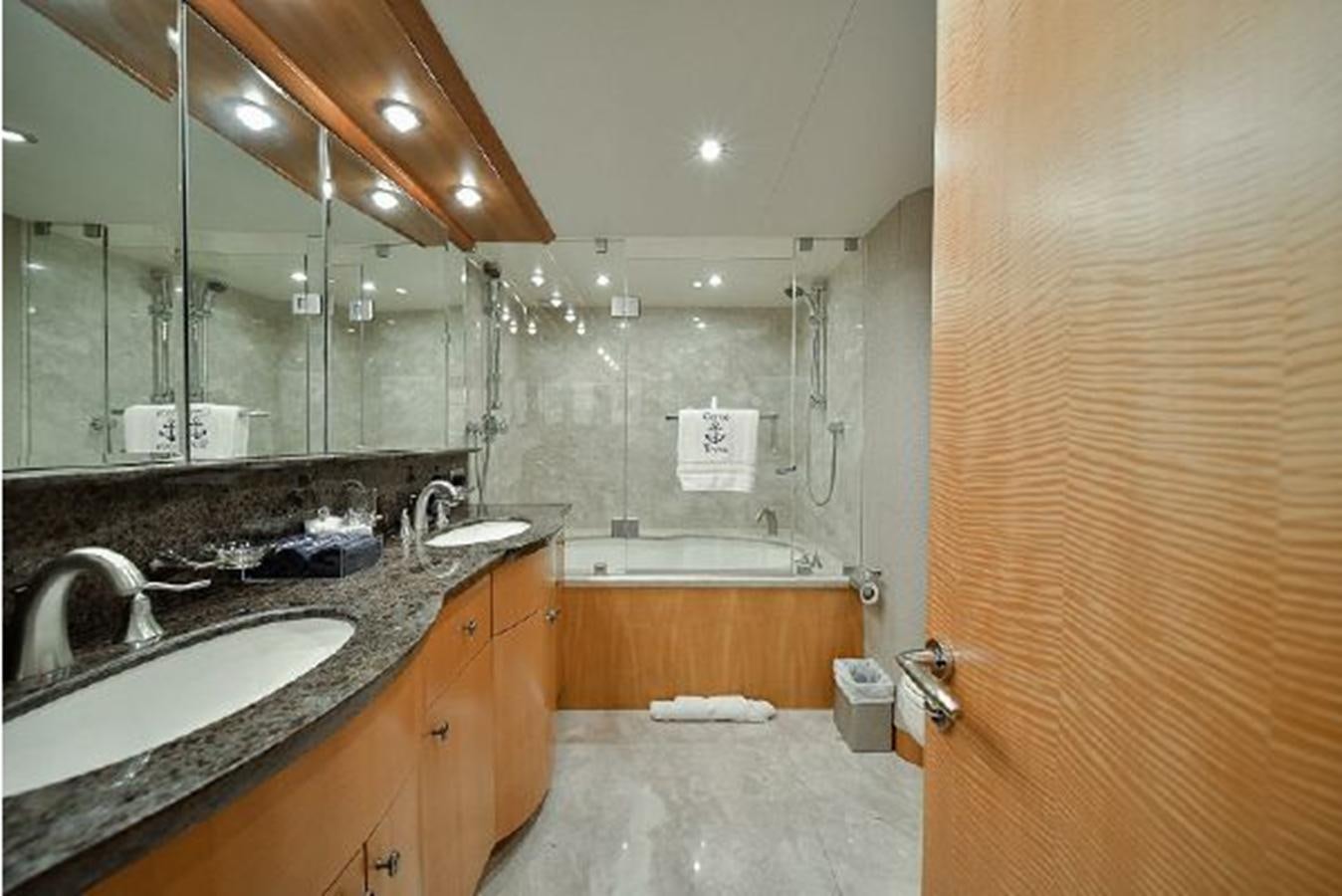 a bathroom with a sink and a bathtub aboard 2007 LAZZARA 84 MOTOR Yacht for Sale