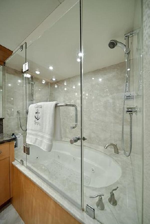 a bathroom with a shower and sink aboard 2007 LAZZARA 84 MOTOR Yacht for Sale