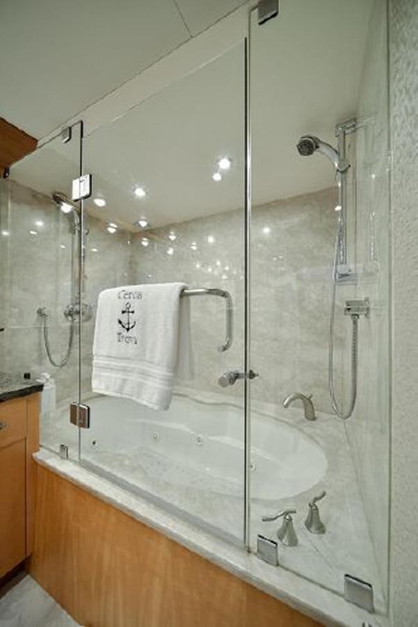 a bathroom with a glass shower aboard 2007 LAZZARA 84 MOTOR Yacht for Sale