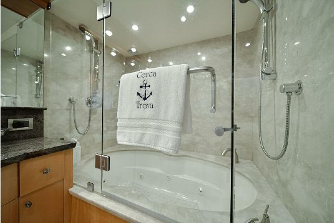 a bathroom with a bathtub and shower aboard 2007 LAZZARA 84 MOTOR Yacht for Sale