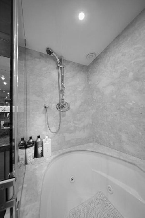 a bathtub with a shower head aboard 2007 LAZZARA 84 MOTOR Yacht for Sale